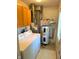 Well-lit laundry room with modern washer, dryer, water heater, and functional storage at 509 Nelson Dr, Brownsburg, IN 46112