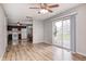 Spacious living room features hardwood floors with an open view of the kitchen and a sliding patio door at 509 Nelson Dr, Brownsburg, IN 46112