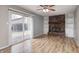 Comfortable living room with hardwood floors, a brick fireplace, built-in shelving, and sliding door access at 509 Nelson Dr, Brownsburg, IN 46112