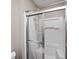 Shower stall with clear glass doors, chrome trim, and built-in shelving at 509 Nelson Dr, Brownsburg, IN 46112