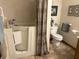 Clean bathroom features an accessible bathtub, toilet, and grab bars for safety at 5122 Montpelier Ct, Columbus, IN 47203