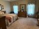 Cozy bedroom with vintage furniture, hardwood flooring and light-filled windows at 5122 Montpelier Ct, Columbus, IN 47203