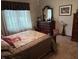 Comfortable bedroom with plush bedding, dark wood furnishings, and plenty of natural light at 5122 Montpelier Ct, Columbus, IN 47203
