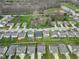 Real estate showcasing a suburban neighborhood with green lawns, fenced yards, and proximity to wooded areas at 5157 Climbing Rose Pl, Indianapolis, IN 46254