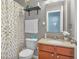 Cozy bathroom featuring neutral tones, a patterned shower curtain, and a vanity with a granite countertop at 5157 Climbing Rose Pl, Indianapolis, IN 46254