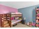 bedroom features bunk beds, a playful color scheme, and ample space for play, creating an inviting atmosphere at 5157 Climbing Rose Pl, Indianapolis, IN 46254