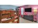 Colorful bedroom featuring bunk beds, a dresser with a TV, and playful decor creating a cheerful space at 5157 Climbing Rose Pl, Indianapolis, IN 46254