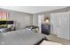 View of bedroom with carpet, grey walls, a large bed, a baby playpen, desk and a walk-in closet at 5157 Climbing Rose Pl, Indianapolis, IN 46254