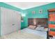 Bedroom with brightly painted walls, large closet, dark wood bedframe, side table, and carpet flooring at 5157 Climbing Rose Pl, Indianapolis, IN 46254