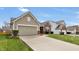 Inviting home showcasing a clean facade, attached two car garage, and well-maintained landscaping at 5157 Climbing Rose Pl, Indianapolis, IN 46254