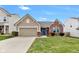 Charming home featuring brick and siding exterior, blue door and shutters, and a well-maintained front yard at 5157 Climbing Rose Pl, Indianapolis, IN 46254