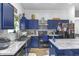 Stylish kitchen features dark cabinetry, stainless steel appliances, and a bright marble countertop for functionality at 5157 Climbing Rose Pl, Indianapolis, IN 46254