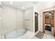 Bathroom featuring soaking tub with tile surround and separate stand up shower with a glass door at 5298 Royal Troon Way, Avon, IN 46123