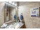 Powder room with stylish textured wall, decorative mirror, vanity and updated fixtures at 5298 Royal Troon Way, Avon, IN 46123
