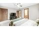 This bedroom offers a ceiling fan and access to an ensuite bathroom at 5298 Royal Troon Way, Avon, IN 46123