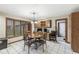 Bright dining area features a round table, decorative light fixture, and large windows overlooking the yard at 5298 Royal Troon Way, Avon, IN 46123