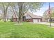 Landscaped front lawn with mature tree, flag pole, and a two-story house with a three-car garage at 5298 Royal Troon Way, Avon, IN 46123