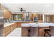 Spacious kitchen featuring wood cabinets, tile backsplash, stainless appliances, and breakfast bar seating at 5298 Royal Troon Way, Avon, IN 46123