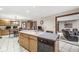 Kitchen island with sink, dishwasher, and seating, open to the living area at 5298 Royal Troon Way, Avon, IN 46123