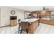 Bright kitchen with island seating, wood cabinets, and modern appliances at 5298 Royal Troon Way, Avon, IN 46123