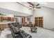 Open living room with beamed ceiling, leather seating, and a built-in bar area at 5298 Royal Troon Way, Avon, IN 46123