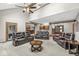 Large living room with vaulted ceiling, fireplace, and comfortable leather seating at 5298 Royal Troon Way, Avon, IN 46123