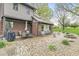 Outdoor brick patio with dining and lounging area surrounded by lush landscaping and greenery at 5298 Royal Troon Way, Avon, IN 46123