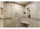 Detailed walk-in shower with beige tile, mosaic accent wall and corner seat at 5298 Royal Troon Way, Avon, IN 46123