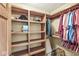 Spacious walk-in closet featuring wood custom shelves and racks for storage at 5298 Royal Troon Way, Avon, IN 46123