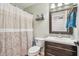 The bathroom features a patterned shower curtain, wood vanity, and a tiled backsplash at 5325 Tracey Jo Rd, Greenwood, IN 46142