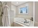 Serene bathroom offers a soaking tub, tile flooring, and a view for the ultimate relaxation experience at 5325 Tracey Jo Rd, Greenwood, IN 46142