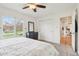 This bedroom boasts a ceiling fan, large window, and access to the hallway at 5325 Tracey Jo Rd, Greenwood, IN 46142