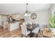 Cozy dining area boasts wood floors, stylish lighting, and easy access to the kitchen and living area at 5325 Tracey Jo Rd, Greenwood, IN 46142