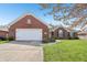 Charming brick home featuring an attached two-car garage and a well-maintained front yard at 5325 Tracey Jo Rd, Greenwood, IN 46142