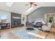 Comfortable living room featuring a fireplace, skylights, hardwood floors, and ample seating at 5325 Tracey Jo Rd, Greenwood, IN 46142