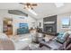 Cozy living room with fireplace, ceiling fan, and skylights, seamlessly flowing into the dining area at 5325 Tracey Jo Rd, Greenwood, IN 46142