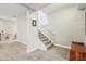 A carpeted staircase with white trim and neutral walls, leading to a naturally lit area at 5325 Tracey Jo Rd, Greenwood, IN 46142