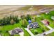 Aerial view of a home on a large grassy parcel of land, with pool, driveway, and landscaping at 5341 W Stonehaven Ln, New Palestine, IN 46163