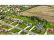 Aerial view of a home and other neighborhood homes in a grassy area, close to other real estate and farmland at 5341 W Stonehaven Ln, New Palestine, IN 46163