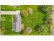 Aerial view of a home with a large green lawn, mature trees, and a driveway leading to the house at 5341 W Stonehaven Ln, New Palestine, IN 46163