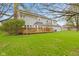 Well-maintained backyard with lush green lawn and a large deck, perfect for outdoor activities and relaxation at 5341 W Stonehaven Ln, New Palestine, IN 46163