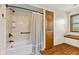 Bathroom features a shower over a tub, tile surround, and a window at 5341 W Stonehaven Ln, New Palestine, IN 46163