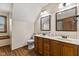 Bathroom featuring double sinks, wood cabinets, a toilet, and laminate floors at 5341 W Stonehaven Ln, New Palestine, IN 46163