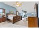 Bedroom features a large bed, vaulted ceilings, and a window seat at 5341 W Stonehaven Ln, New Palestine, IN 46163