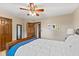 Comfortable bedroom with a ceiling fan, wood doors, and stylish decor at 5341 W Stonehaven Ln, New Palestine, IN 46163