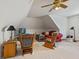 Bright bonus room with rocking chairs, a love seat, and a ceiling fan with lighting at 5341 W Stonehaven Ln, New Palestine, IN 46163
