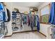 Walk-in closet with ample storage, shelving, and racks for clothes, shoes and storage bins near a window at 5341 W Stonehaven Ln, New Palestine, IN 46163