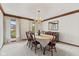 Formal dining room with light-colored carpet, white walls, a decorative ceiling, and windows with curtains at 5341 W Stonehaven Ln, New Palestine, IN 46163