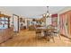 Open dining room and kitchen area featuring wood floors and ample natural light at 5341 W Stonehaven Ln, New Palestine, IN 46163