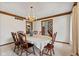 Formal dining room showing the white walls, chandelier, and access to the staircase at 5341 W Stonehaven Ln, New Palestine, IN 46163